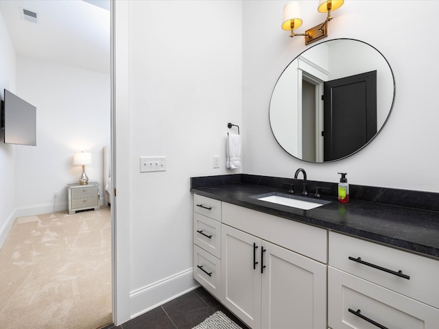 bathroom with tile patterned floors, baseboards, visible vents, and vanity