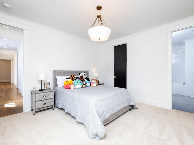 bedroom featuring baseboards, ornamental molding, and carpet flooring