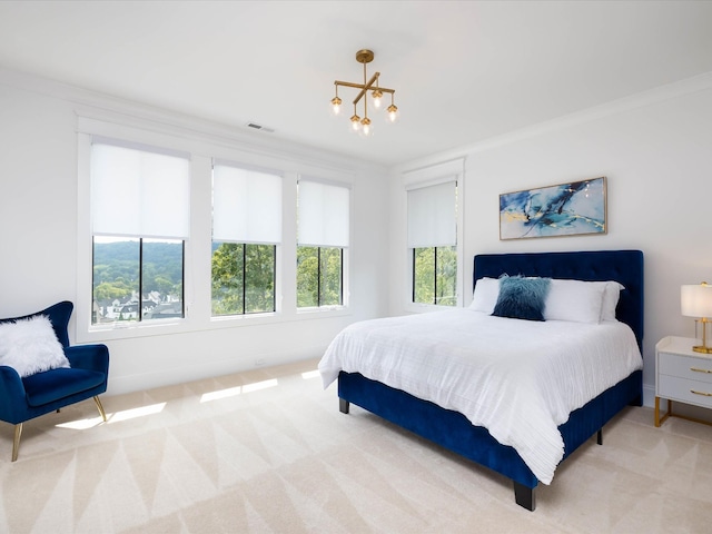 bedroom with light carpet, ornamental molding, and a chandelier