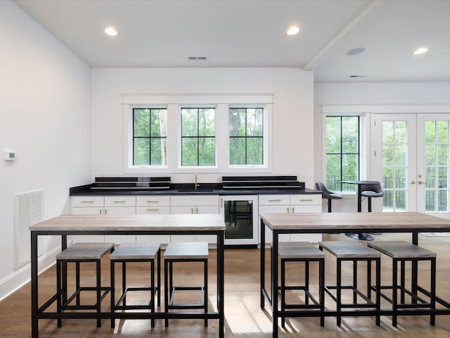 kitchen featuring dark countertops, visible vents, and white cabinets