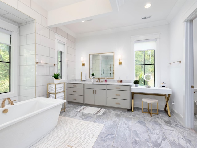 full bath featuring a freestanding bath, a stall shower, plenty of natural light, and visible vents