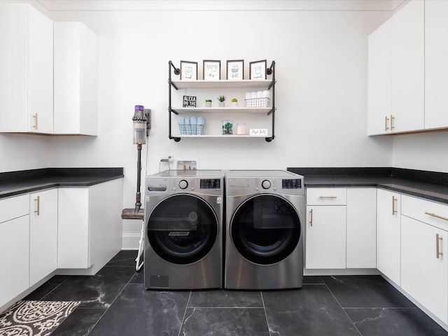 clothes washing area featuring cabinet space and washer and dryer