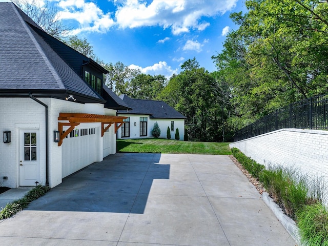 exterior space featuring driveway and fence