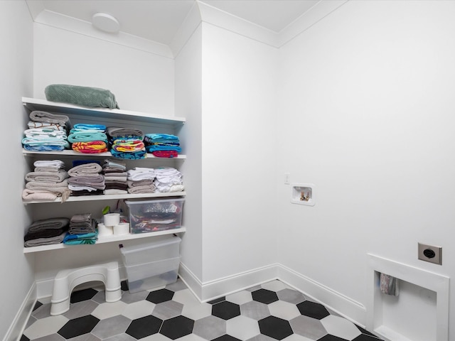 washroom featuring crown molding, tile patterned floors, and hookup for an electric dryer