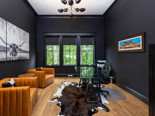 office space featuring light wood finished floors, baseboards, and crown molding