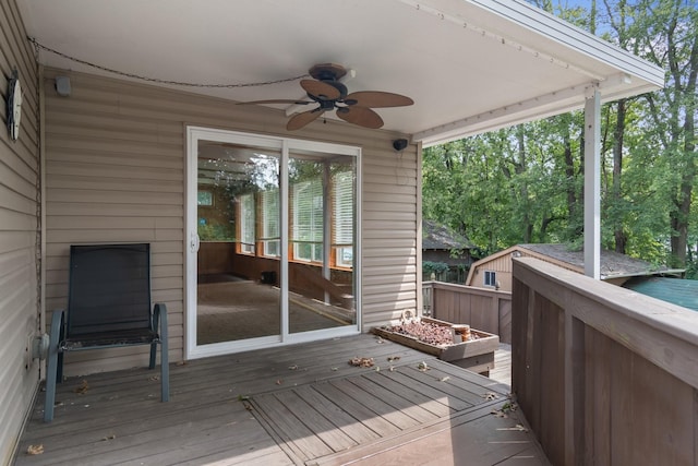 wooden terrace with a ceiling fan