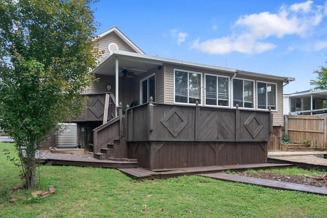 exterior space with a yard, stairway, a ceiling fan, fence, and a wooden deck