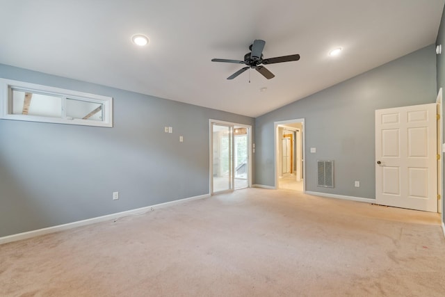 empty room with baseboards, visible vents, vaulted ceiling, and a ceiling fan