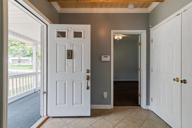 foyer entrance with light tile patterned floors, ornamental molding, wood ceiling, and a wealth of natural light