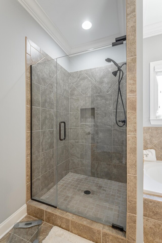 bathroom with a stall shower and crown molding