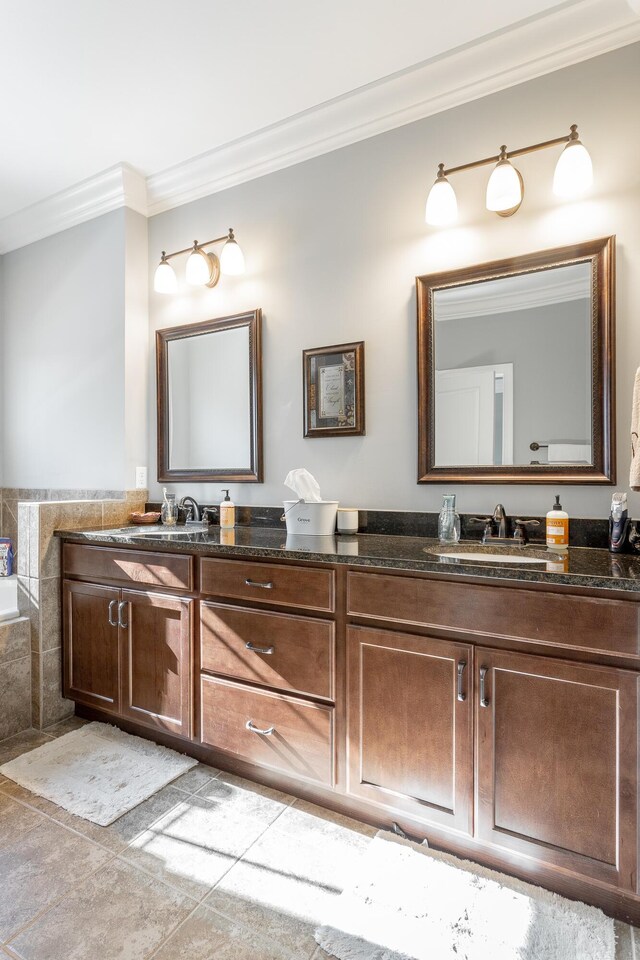 bathroom with crown molding, a sink, and double vanity