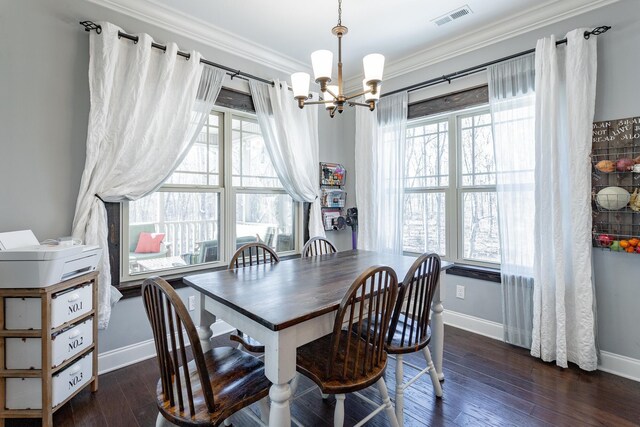 dining space featuring dark wood-style floors, plenty of natural light, visible vents, and ornamental molding