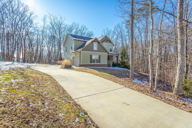 view of property exterior featuring driveway and board and batten siding