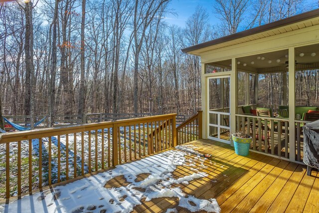 wooden deck with a sunroom and fence