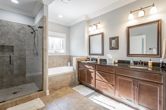 full bathroom with a sink, a garden tub, tile patterned flooring, and crown molding