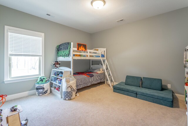 bedroom featuring carpet, visible vents, and baseboards