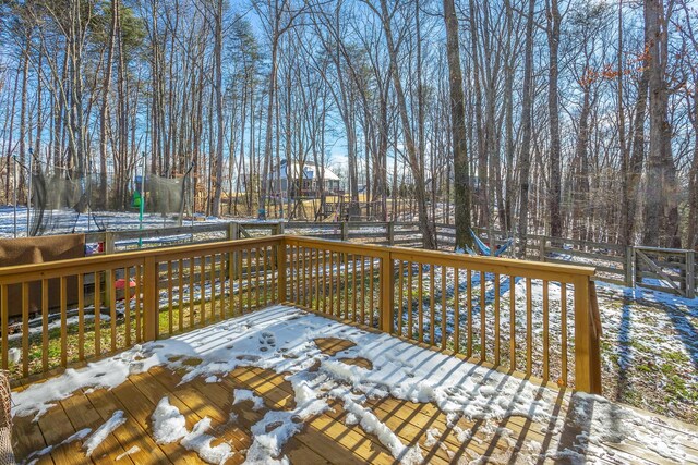 snow covered deck with a trampoline