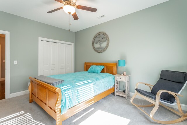 bedroom featuring light colored carpet, a closet, visible vents, and baseboards