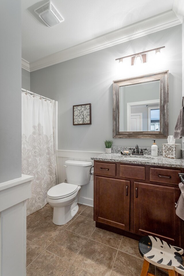 bathroom featuring toilet, vanity, visible vents, ornamental molding, and tile patterned floors