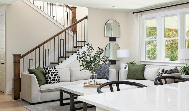 living room with light wood-style floors and stairs