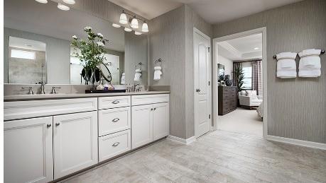 full bath featuring double vanity, connected bathroom, a sink, wood finished floors, and baseboards