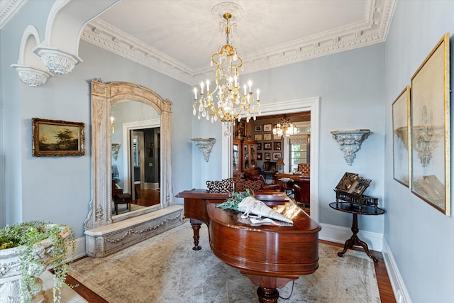 hallway featuring arched walkways, wood finished floors, crown molding, and an inviting chandelier