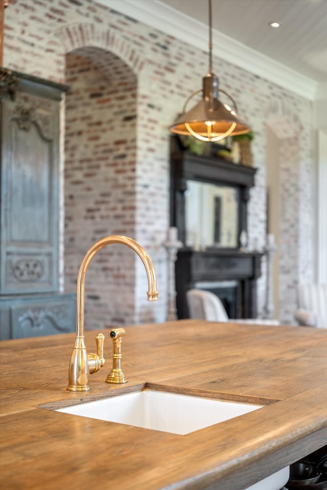 interior details with ornamental molding and a sink