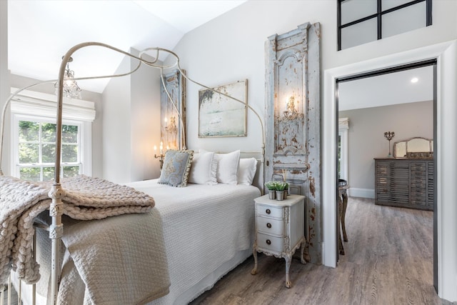 bedroom featuring vaulted ceiling and wood finished floors