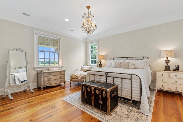 bedroom with multiple windows, light wood-type flooring, and visible vents