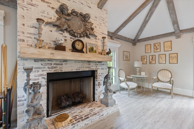 unfurnished living room with vaulted ceiling with beams, a fireplace, wood finished floors, and baseboards