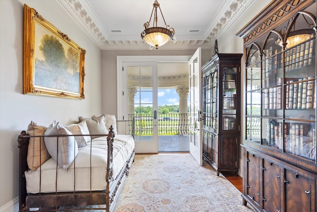 interior space featuring baseboards, visible vents, crown molding, and french doors