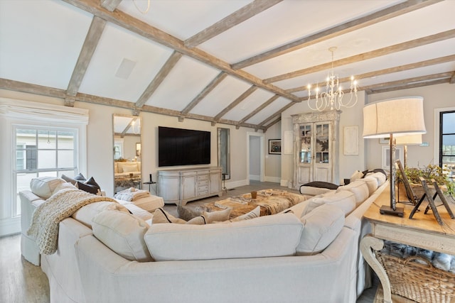 living area with vaulted ceiling with beams, baseboards, and a chandelier