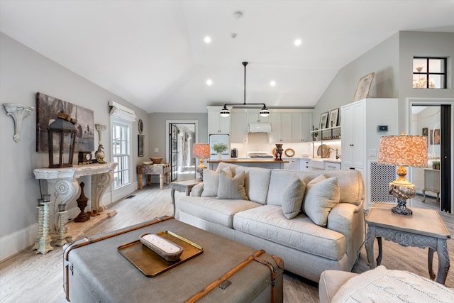 living room featuring light wood-style floors, recessed lighting, high vaulted ceiling, and baseboards