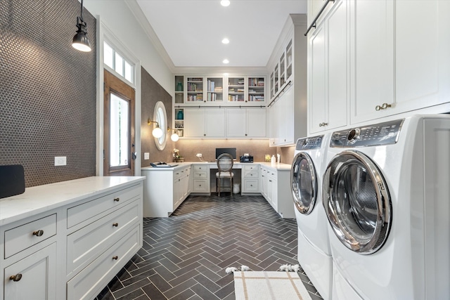 laundry room with brick patterned floor, washer and clothes dryer, cabinet space, and recessed lighting