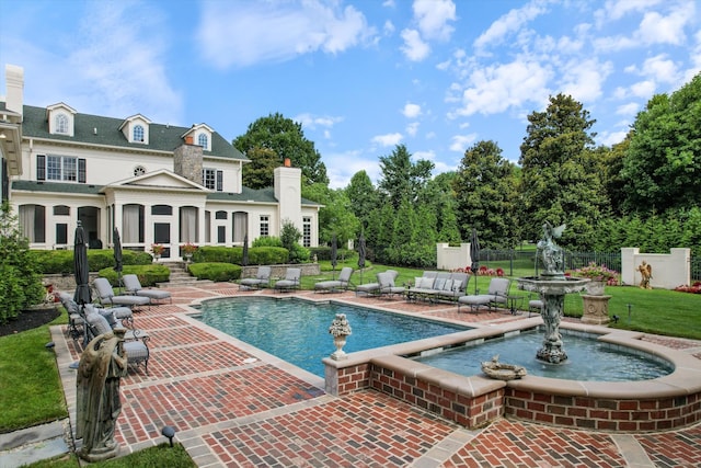 pool featuring a yard and fence