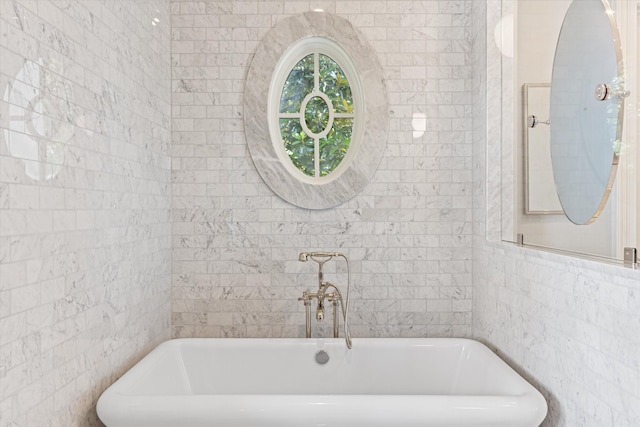 full bath featuring a freestanding bath and tile walls