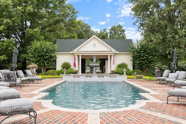 outdoor pool featuring outdoor lounge area, a patio area, an outdoor structure, and an exterior structure