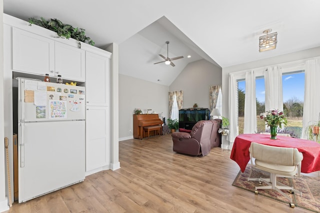 interior space featuring ceiling fan, recessed lighting, baseboards, vaulted ceiling, and light wood-type flooring