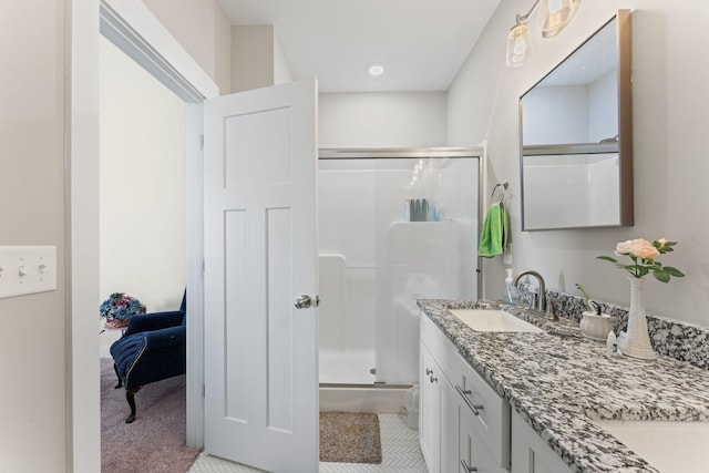 ensuite bathroom with a stall shower, tile patterned flooring, ensuite bath, and vanity