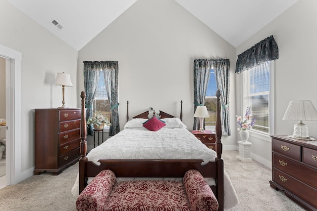 bedroom featuring baseboards, high vaulted ceiling, visible vents, and light colored carpet