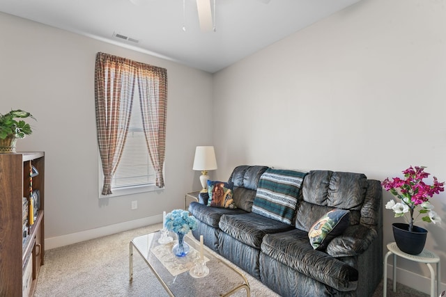 living area with visible vents, light carpet, and baseboards