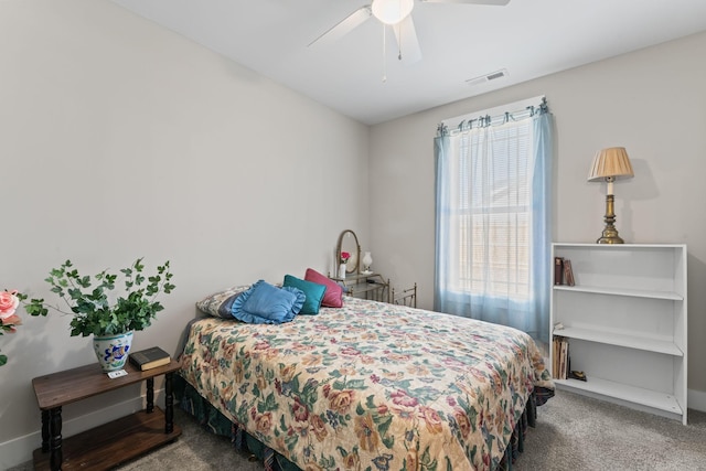 carpeted bedroom featuring baseboards, visible vents, and a ceiling fan