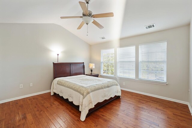 bedroom with visible vents, vaulted ceiling, and dark wood-type flooring