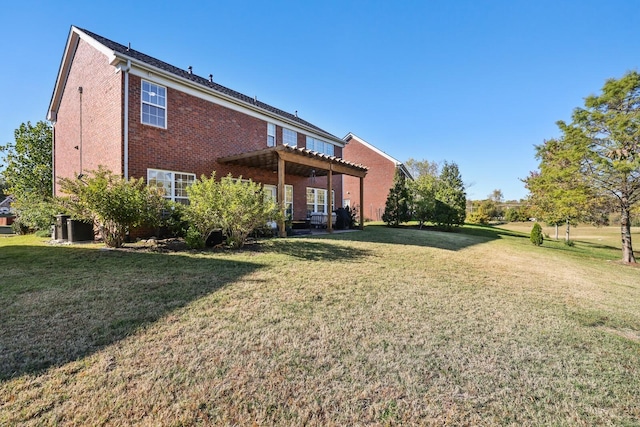 rear view of house with brick siding, a lawn, and a pergola