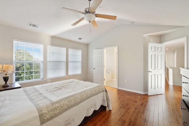 bedroom featuring lofted ceiling, baseboards, visible vents, and dark wood-style flooring