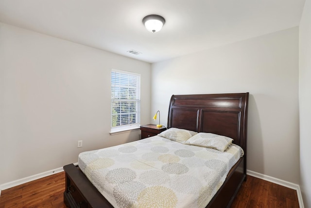 bedroom with dark wood-type flooring, visible vents, and baseboards