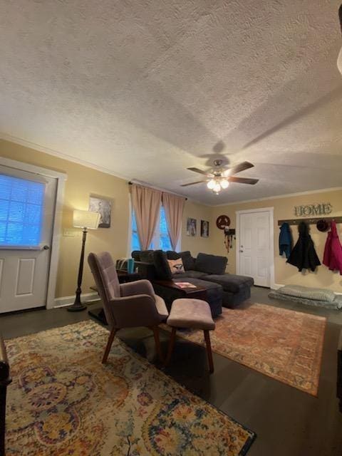 living area featuring crown molding, a textured ceiling, and ceiling fan