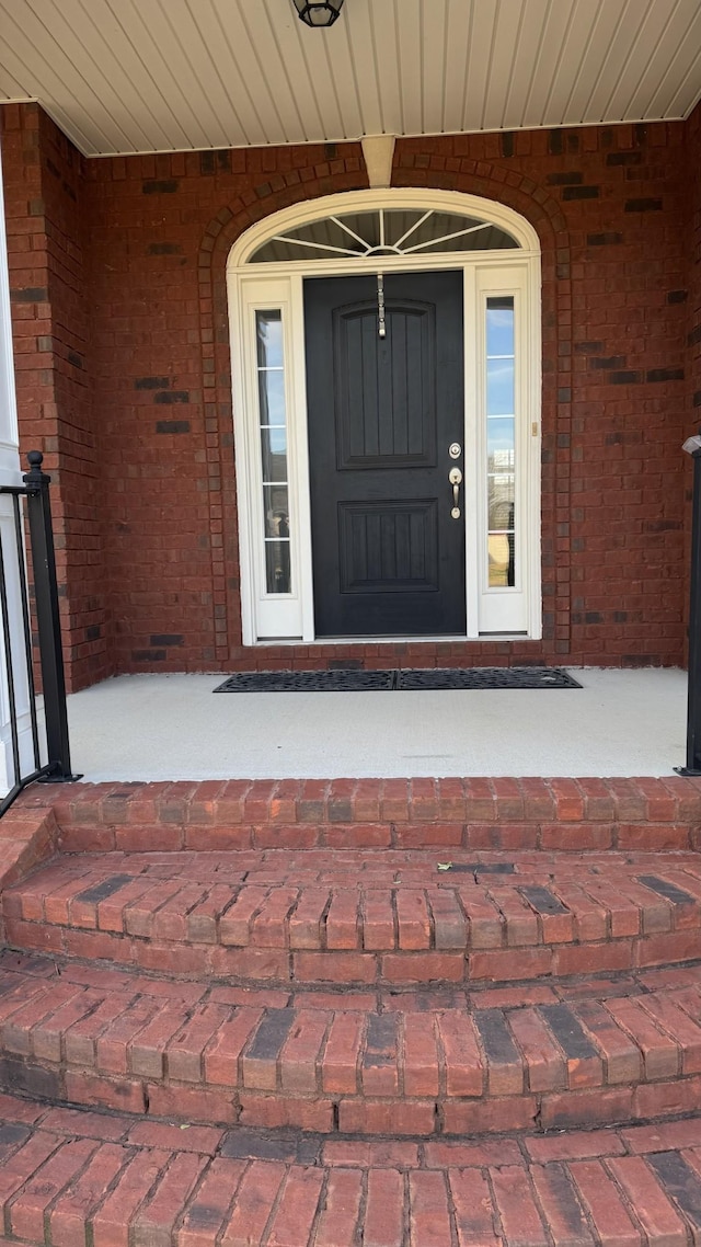 property entrance with brick siding