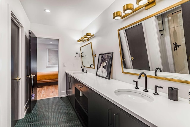 bathroom with double vanity, ensuite bath, and a sink