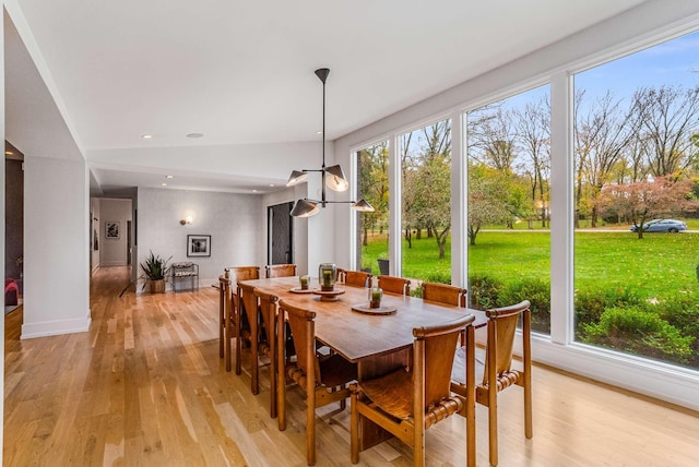 dining space with light wood-type flooring, vaulted ceiling, and recessed lighting